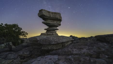 tree and rock formation against night sky