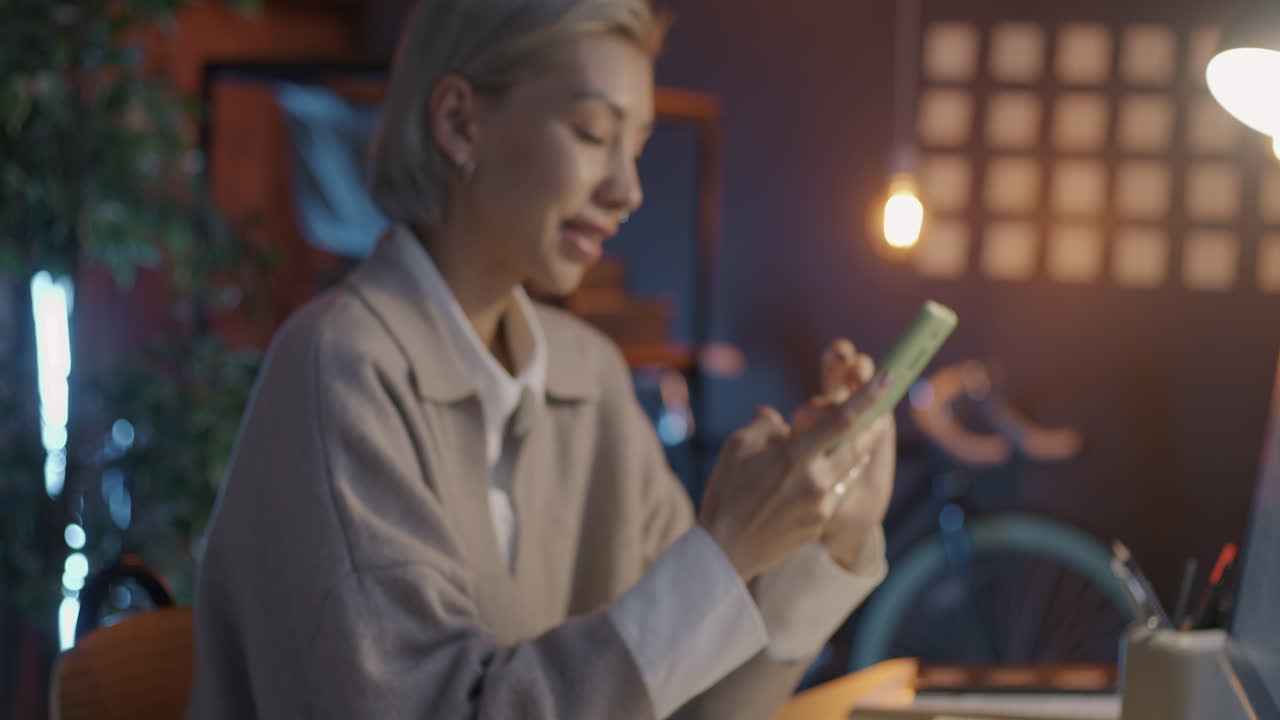 Woman Working on Smartphone in Modern Office