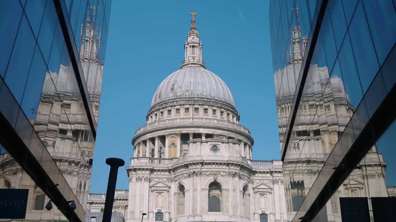 St. Paul's Cathedral Street View Reflected On Building Glass Facade In The City Of London, United Kingdom. Tilt-up Shot