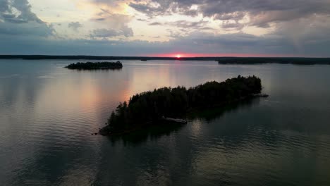 aerial orbit of small islands on lake huron at sunset, les cheneaus islands water reflection