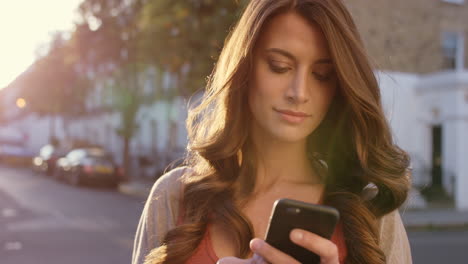 a woman using her cellphone while out in the city