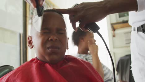 african man cleaning african boy face