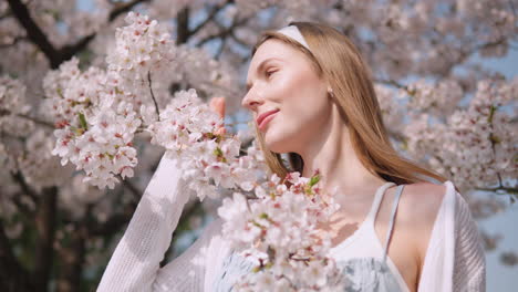 lovely model posing on sakura blooming flower trees at yangjae citizen's forest park in springtime in seocho district, seoul city, south korea