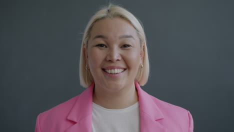 smiling woman in pink blazer