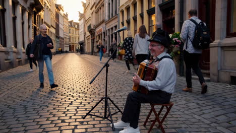 street musician in european old town at sunset