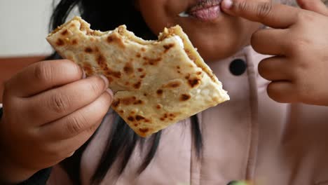 child eating paratha