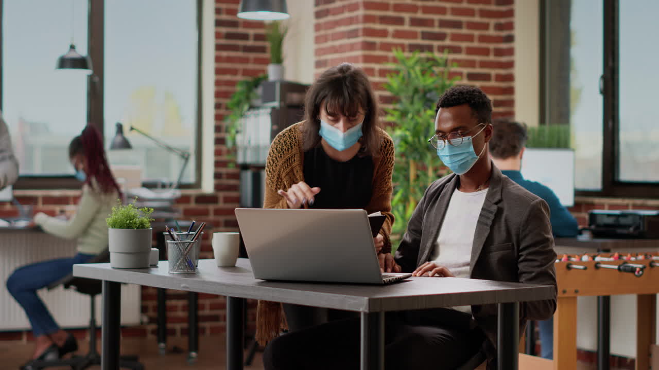 Diverse team of coworkers analyzing charts information