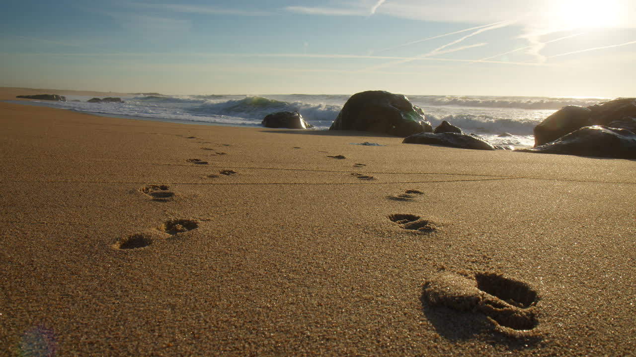 Miramar Beach With Footprints In The Sand During Sunrise In Vila Nova de Gaia, Portugal. Static Shot