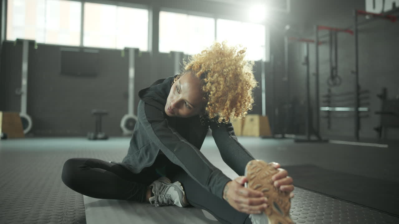 Woman Stretching at the Gym