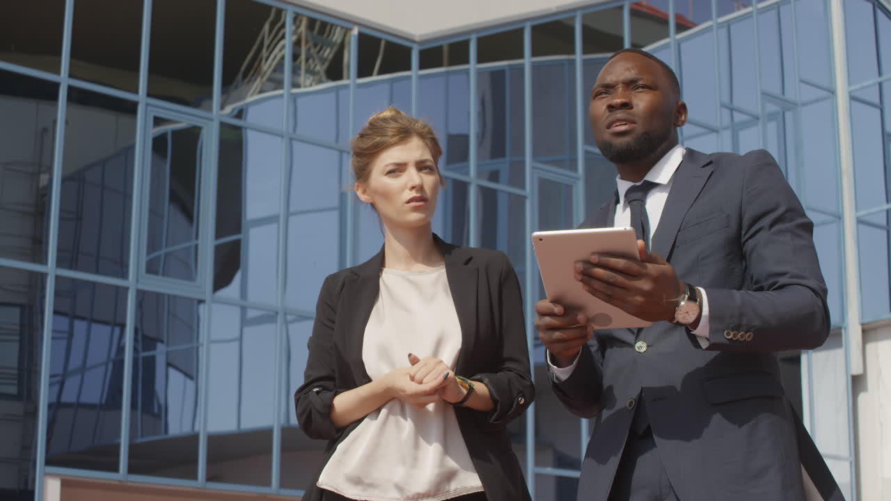 Business Couple With Tablet Chatting Near Office