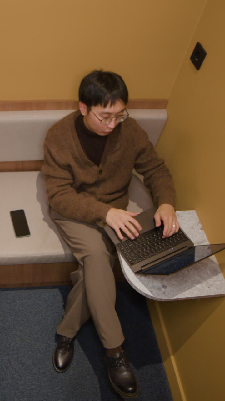 Man working on laptop indoors