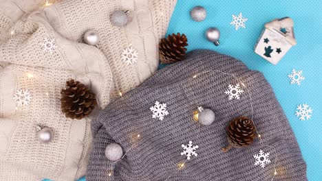 knitted wear with blinking lights and winter decoration on blue theme. stop motion