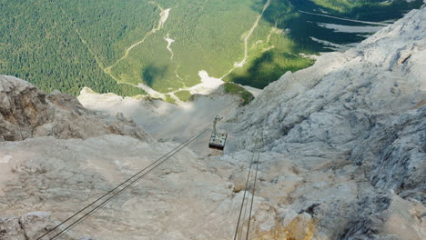 from the summit of the hill, one can witness the awe-inspiring panorama featuring chairlifts, majestic mountain ranges, and the gracefully meandering wires that embellish the landscape