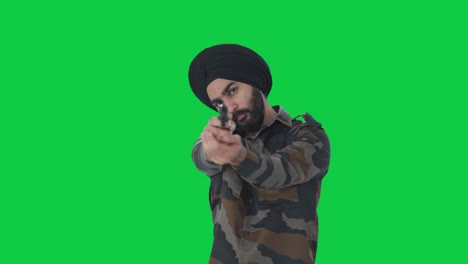 serious sikh indian army man pointing gun towards enemy green screen