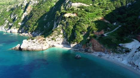 sunset aerial view of kefalonia with clear blue waters and dramatic coastal mountains