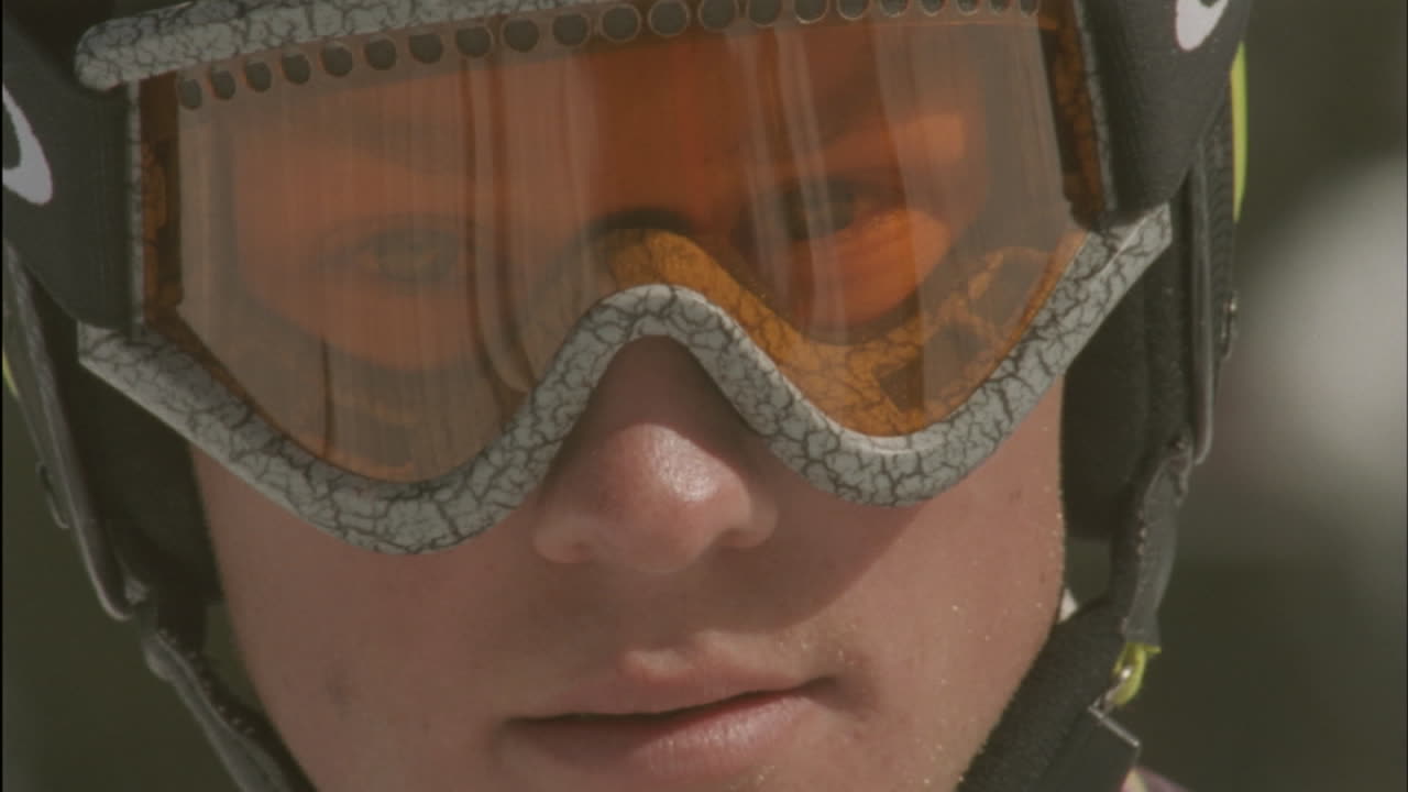 A child looks through goggles in a ski helmet