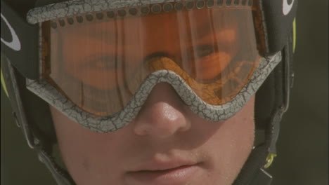 a child looks through goggles in a ski helmet