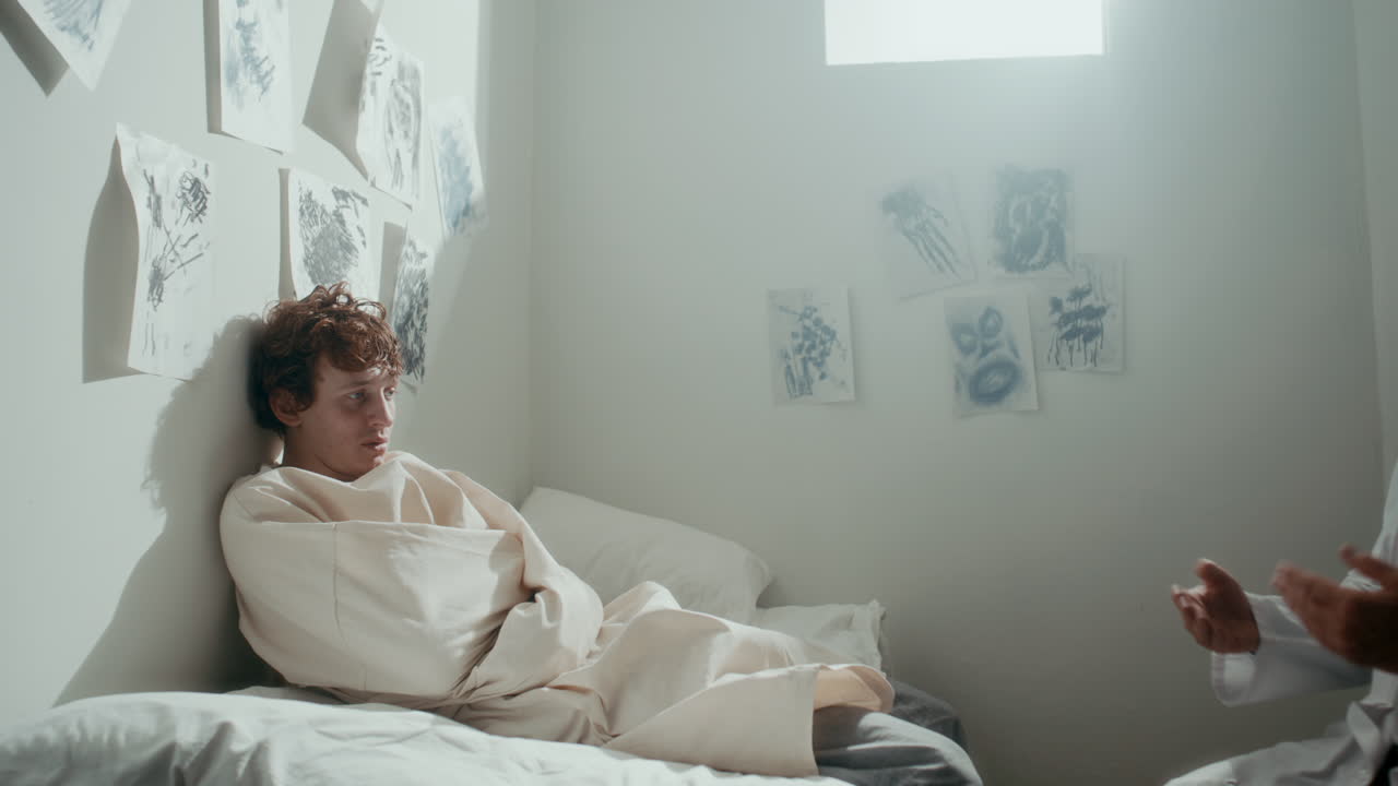 Psychiatrist Visiting Young Patient with Mental Disorder in Seclusion Room