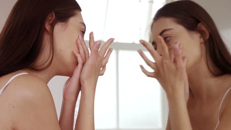 Young-woman-removing-her-contact-lenses