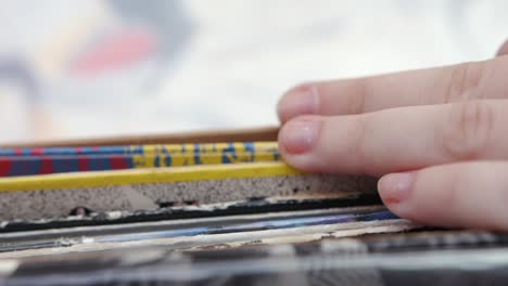 person browsing through a stack of vintage records and books