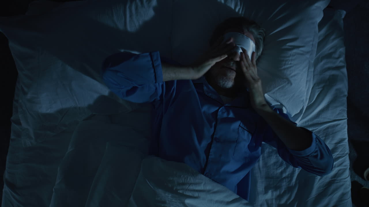 Man in Bed Illuminated By Cold Moonlight Suffers From Insomnia