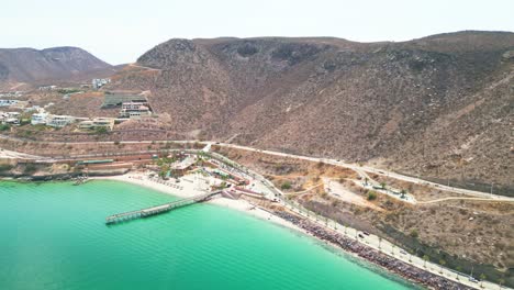 playa coromuel, la paz, showing beach, pier, and mountains, aerial view