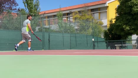 male professional tennis player hits the ball with a racket, practice game on the tennis court, hits off the opponent's serve during tennis match, 4k slow motion