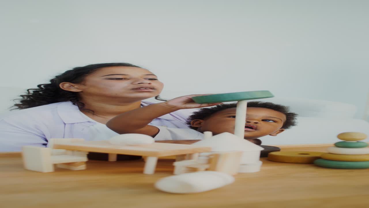 Mother and Child Playing with Wooden Toys