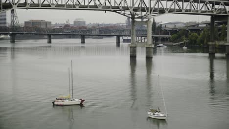 Pan-up-shot-of-downtown-portland-on-the-riverfront-with-sailboats-and-bridges