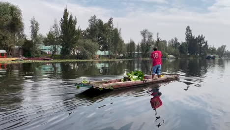 shot of peasant transporting merchandise through the canal