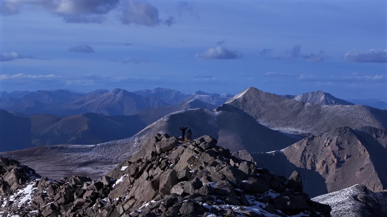 Hikers top of snow covered Mt Mount Shavano Taeguache Peak aerial drone Colorado Collegiate peaks golden hour Rocky Mountains Huron Peak Mt Elbert Sawatch Range fall autumn parallax circle motion