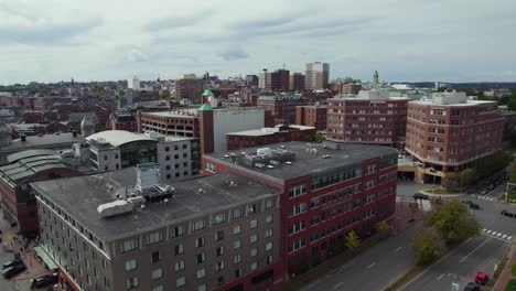 aerial take off over portland city neighborhood area building rooftops, maine