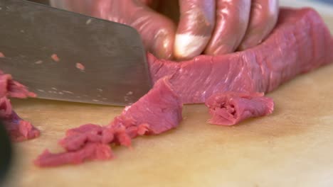 chinese chef precisely slicing meat - authentic scene