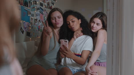 happy teenage girls taking selfie photos together using smartphone best friends posing enjoying making faces hanging out at home sharing weekend on social media