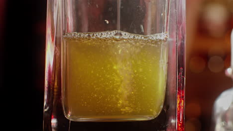 pouring a cocktail into a glass