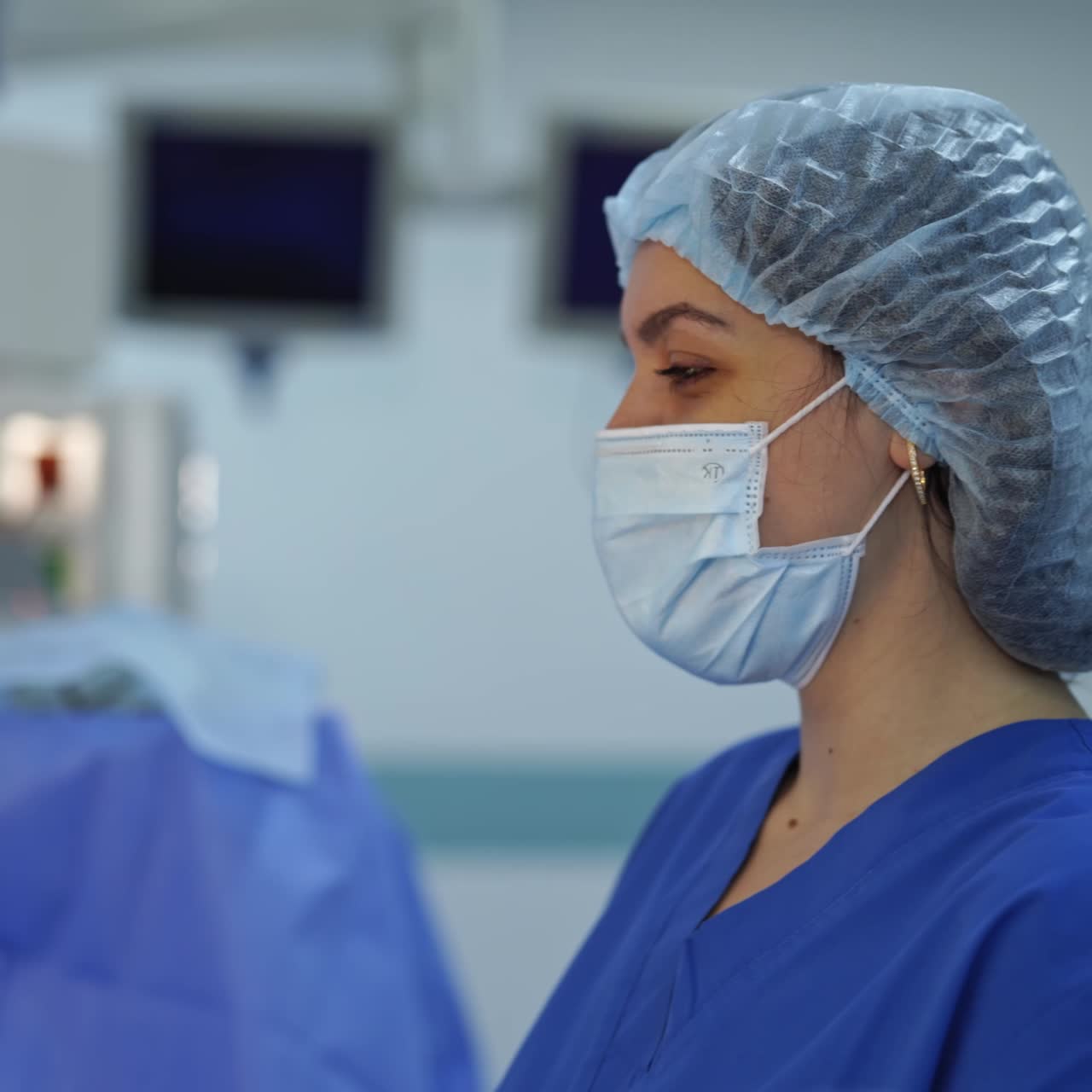 Doctor in uniform working in emergency ward. Surgery female in medical mask