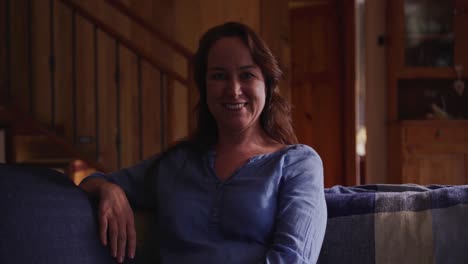 Portrait-of-a-happy-woman-sitting-at-home