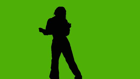 studio silhouette of woman dancing against green background