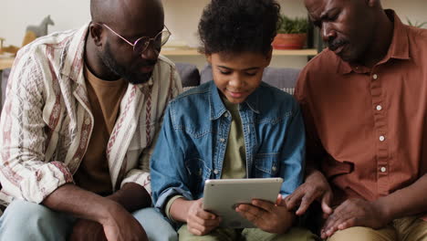 boy playing video games with family