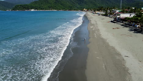 Flying-Over-Waves-Fading-Smoothly-On-Long-Sandy-Beach,-Baler,-Philippines