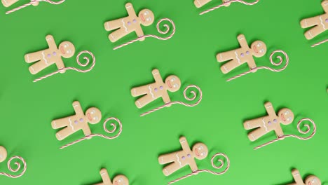 Gingerbread-Men-and-Candy-Canes-on-a-green-background-vertical