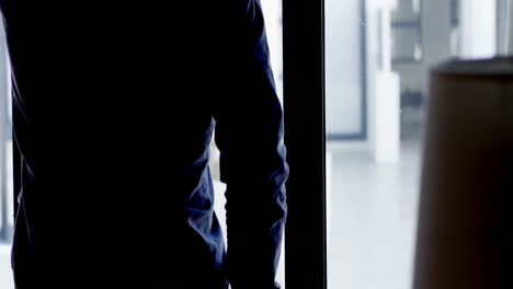 man looking through window at home 4k