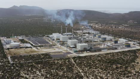 aerial view of a power station emitting smoke in the middle of nowhere