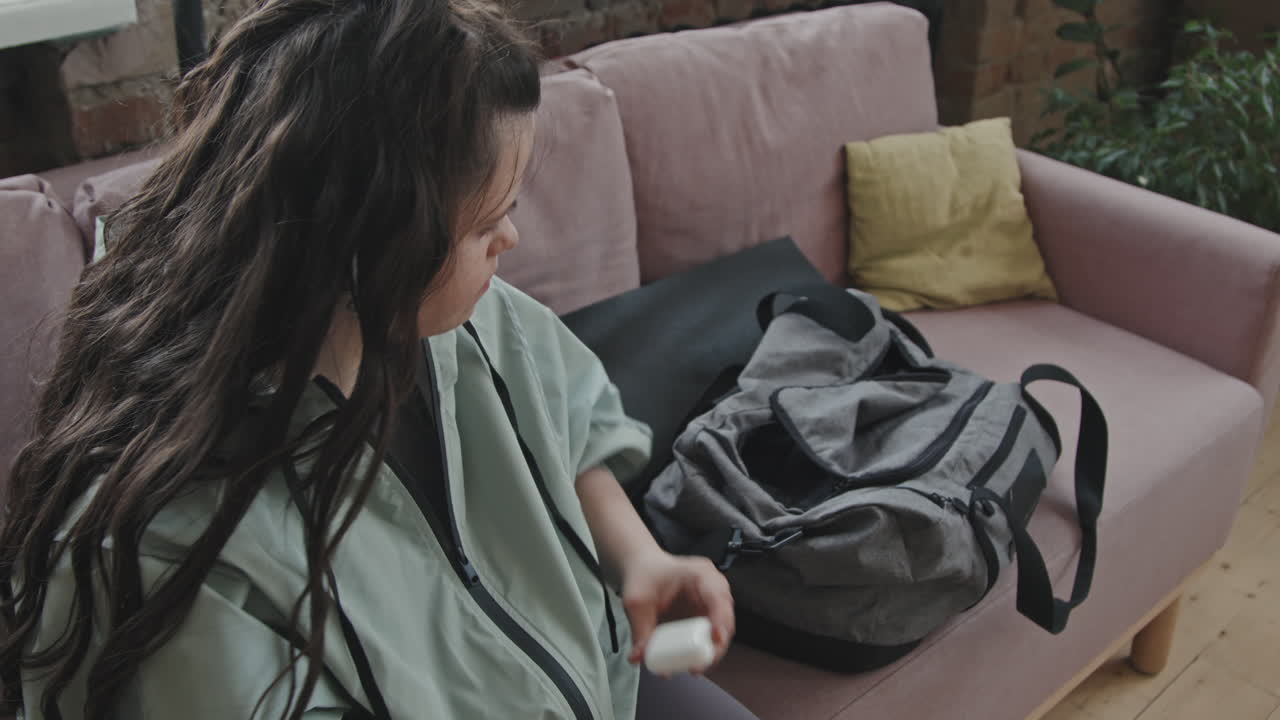 Active Young Woman With Down Syndrome Preparing For Workout