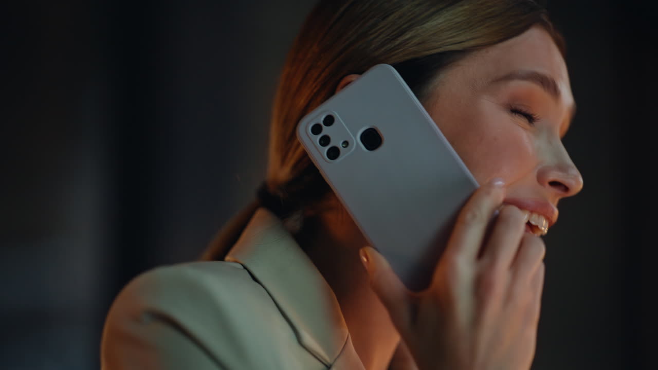 Portrait evening businesswoman talking cellphone at dark cabinet. Woman calling