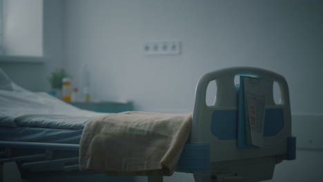 closeup empty hospital bed with medical records attached in intensive care unit.