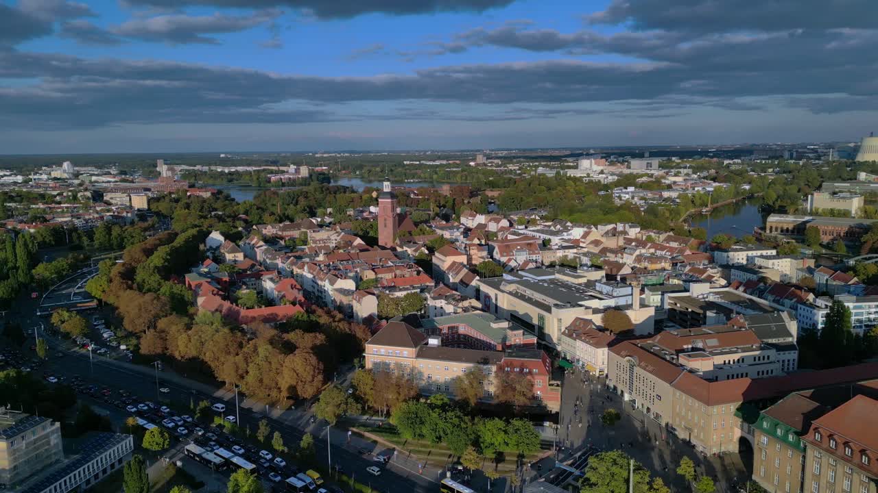 Berlin Spandau old town with its red rooftops, churches, and surrounding greenery. Majestic aerial view flight wide orbit overview drone
