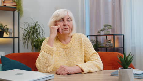 senior woman at home suffers from unfair situation problem break up depression bad sick ill annoyed