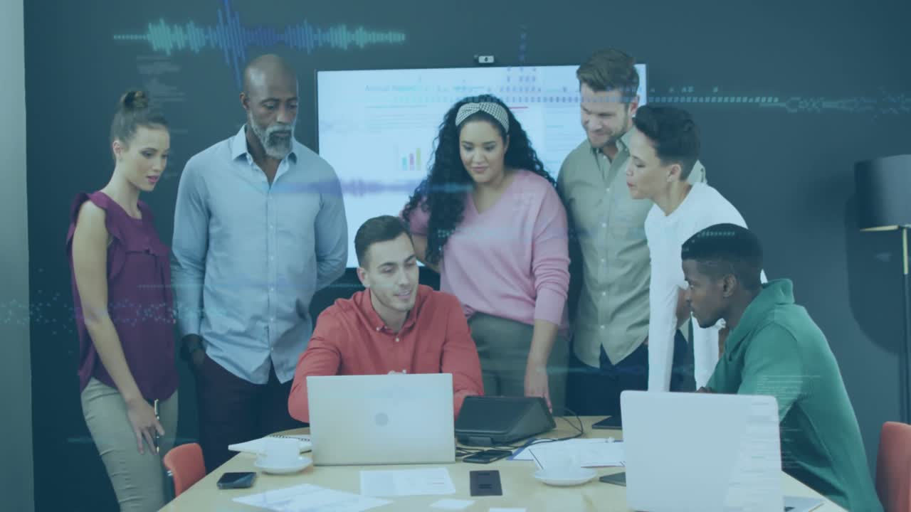 A group of diverse businesspeople discuss work during a meeting at a modern office