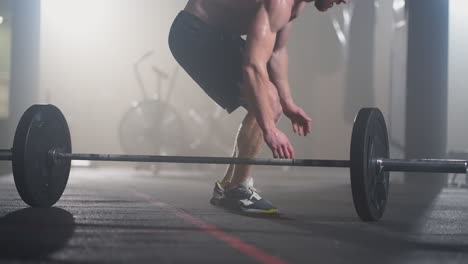 Fitness-man-doing-burpee-workout-at-gym.-Medium-shot-of-young-man-doing-push-ups-and-jump-exercise-in-slow-motion.-Sport-concept